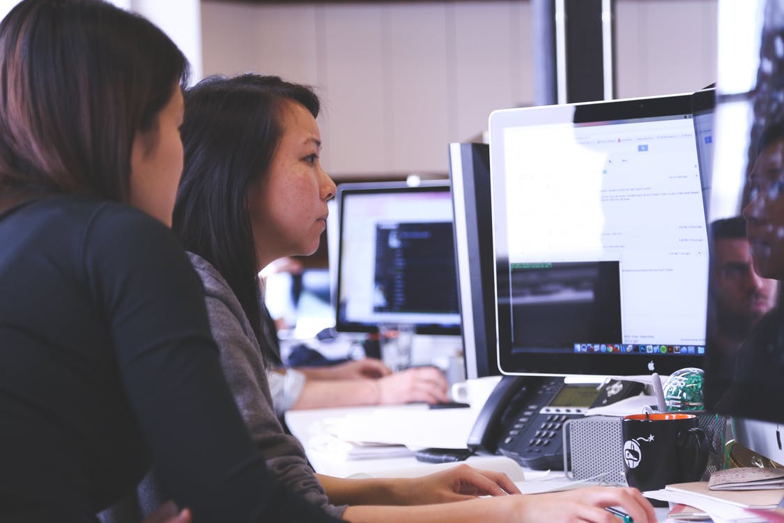 women in front of computer